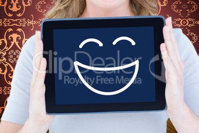 Composite image of portrait of happy woman showing digital table