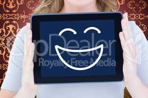 Composite image of portrait of happy woman showing digital table