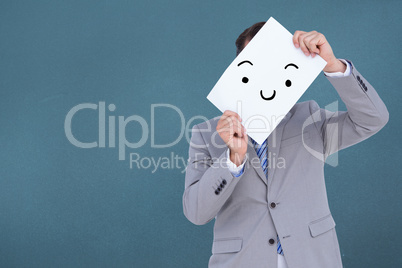 Composite image of businessman holding blank sign in front of hi