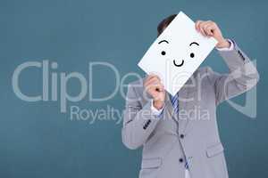 Composite image of businessman holding blank sign in front of hi