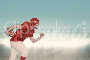 Composite image of american football player running with the bal