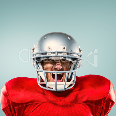 Composite image of aggressive american football player in red je