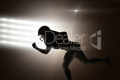Composite image of silhouette american football player running