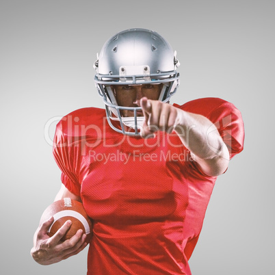 Composite image of portrait sports player in red jersey pointing