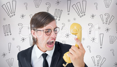 Composite image of geeky businessman shouting at retro phone