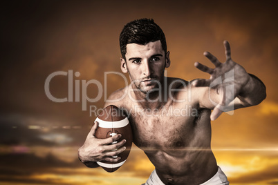 Composite image of shirtless rugby player defending