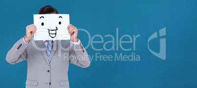 Composite image of businessman holding blank sign in front of hi