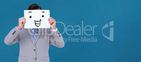 Composite image of businessman holding blank sign in front of hi