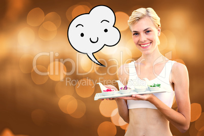 Composite image of happy blonde woman holding plate with herbal