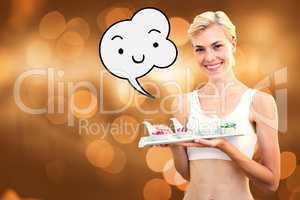 Composite image of happy blonde woman holding plate with herbal