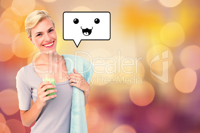 Composite image of fit woman holding healthy juice and towel