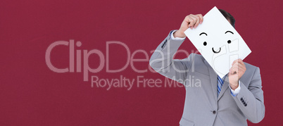 Composite image of businessman holding blank sign in front of hi