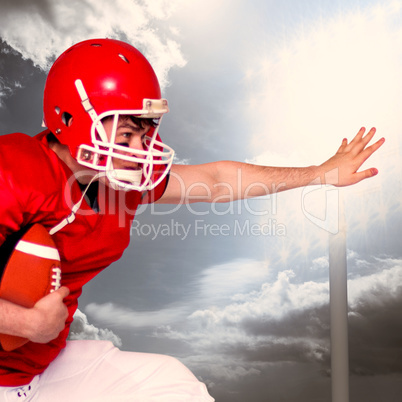 Composite image of american football player jumping with the bal