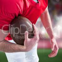 Composite image of american football player taking a ball on her