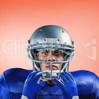 Composite image of portrait of serious sportsman holding helmet