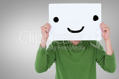 Composite image of man holding blank sign in front of face