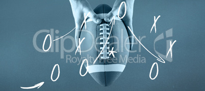 Composite image of american football player holding up football