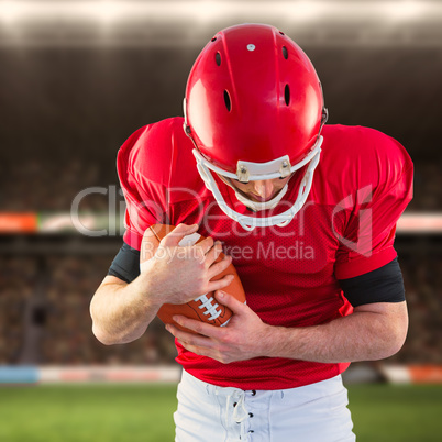 Composite image of american football player protecting football