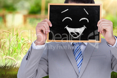 Composite image of businessman showing board