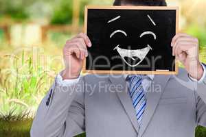 Composite image of businessman showing board