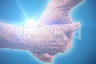 Composite image of elderly couple holding hands