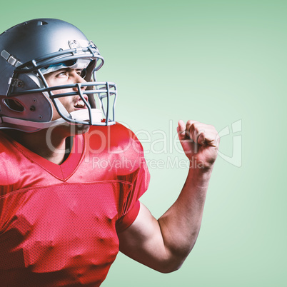Composite image of american football player cheering with clench