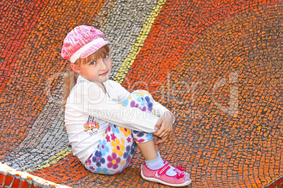 Little girl sitting on the big mosaic panel