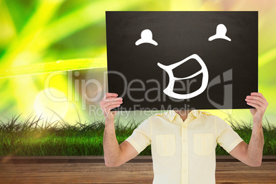 Composite image of casual man showing board