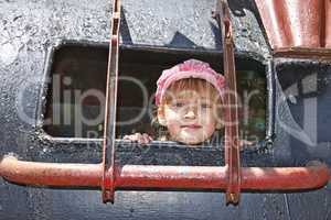 Little girl inside a welded metal attraction