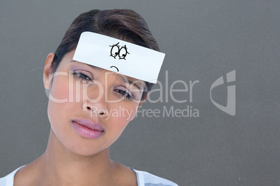 Composite image of portrait of upset woman with blank note on fo