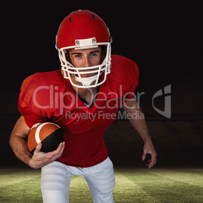 Composite image of rugby player with ball posing