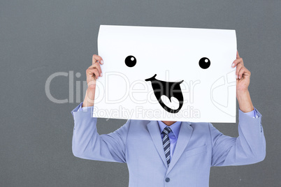 Composite image of  portrait of a businessman hiding his face be