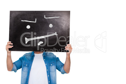 Composite image of casual man showing board