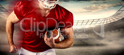 Composite image of american football player holding ball