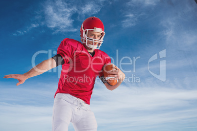 Composite image of american football player protecting football