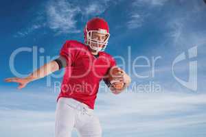 Composite image of american football player protecting football