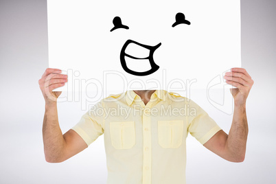 Composite image of man holding card in front of his face