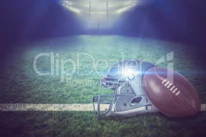 Composite image of american football helmet and ball