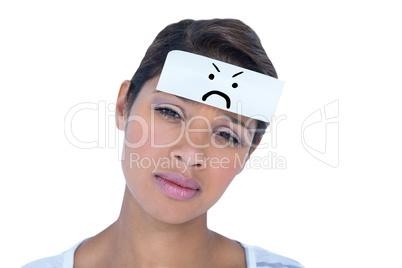 Composite image of portrait of upset woman with blank note on fo