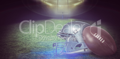 Composite image of american football helmet and ball
