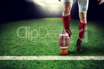 Composite image of low section of sports player kicking ball