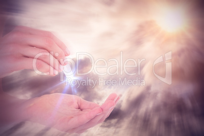 Composite image of woman holding precious gem
