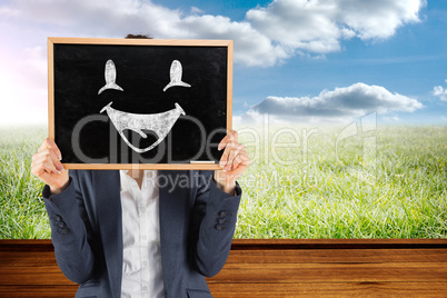 Composite image of businesswoman showing board