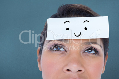 Composite image of beautiful woman with blank note on forehead