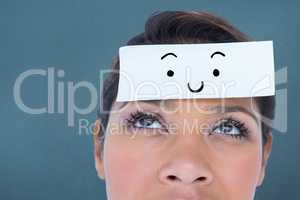 Composite image of beautiful woman with blank note on forehead