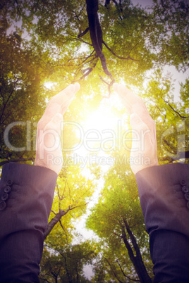 Composite image of businessman holding his hand out