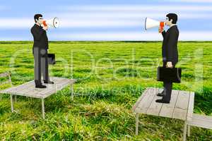 Businessman with megaphone standing on table in the meadow