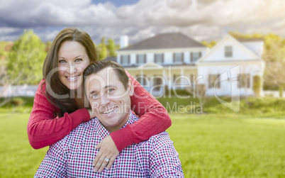 Happy Couple Outdoors In Front of Beautiful House