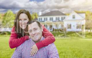 Happy Couple Outdoors In Front of Beautiful House