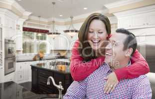 Happy Laughing Couple In Beautiful New Kitchen